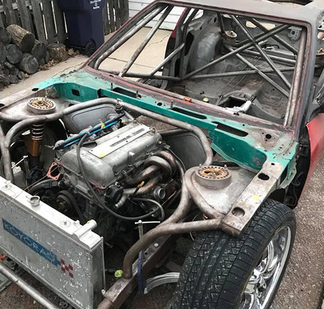 Open view of a car chassis with engine exposed.
