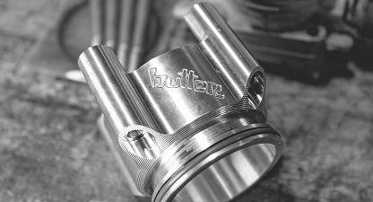 Black and white metal part with "Butter" engraving