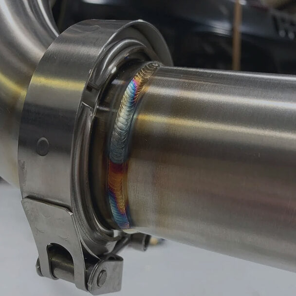 Close-up of a colorful weld on a metal pipe.