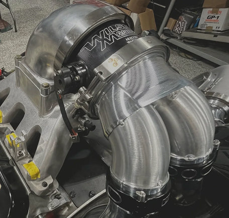 Close-up view of a car's turbocharger and piping system.