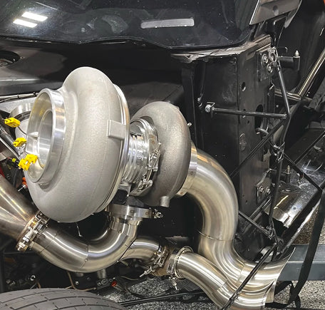 Close-up view of a car's turbocharger and piping system.